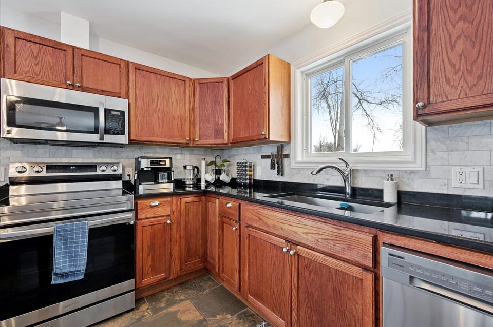 Fully refreshed kitchen with modern countertops, stainless-steel appliances, and plenty of space to prep meals.