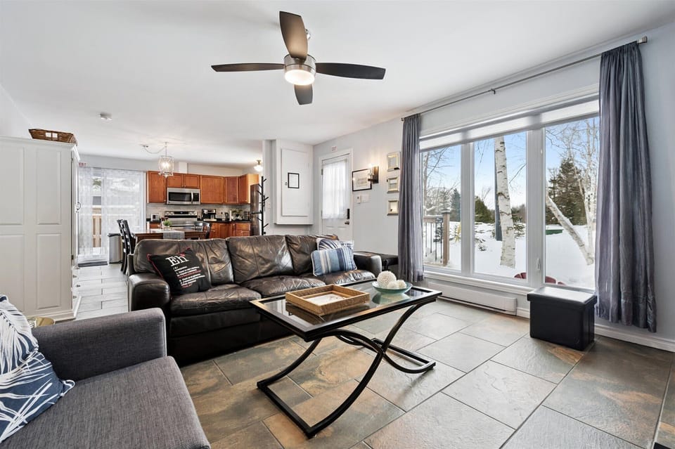 Sun-filled living space with energy-efficient windows and updated flooring throughout.