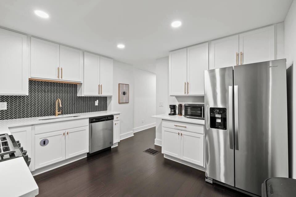 Enjoy a bright, modern kitchen designed for comfort and convenience. This fully equipped space features a gas stove and oven, microwave, full-size refrigerator with freezer, and dishwasher. Start your mornings with the coffee. 