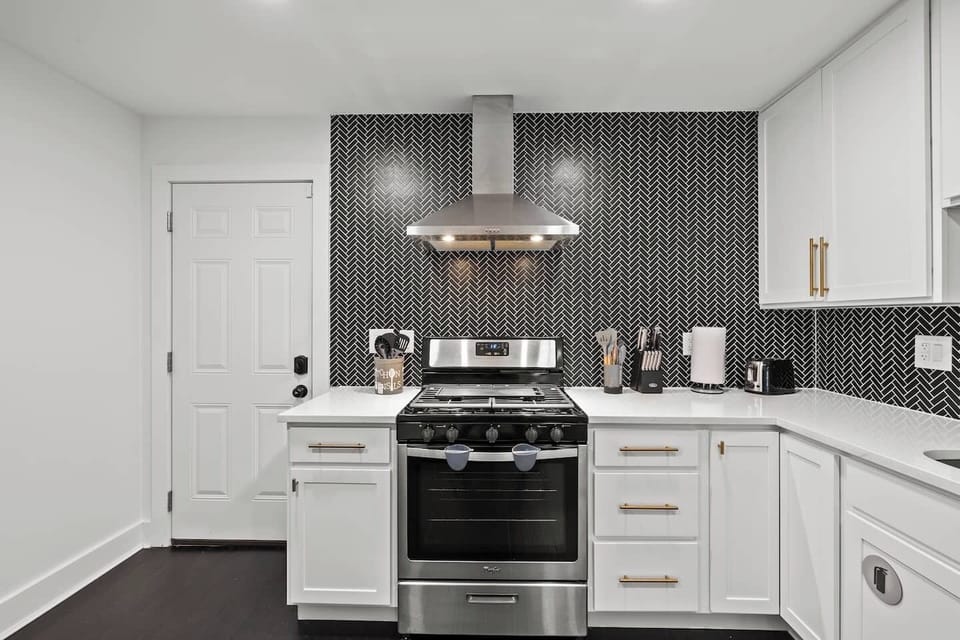 Modern, fully equipped kitchen with a gas stove and oven, microwave, refrigerator/freezer, and dishwasher. Enjoy cooking with ample counter space plus a coffee pot, toaster, and electric tea kettle for easy mornings.
