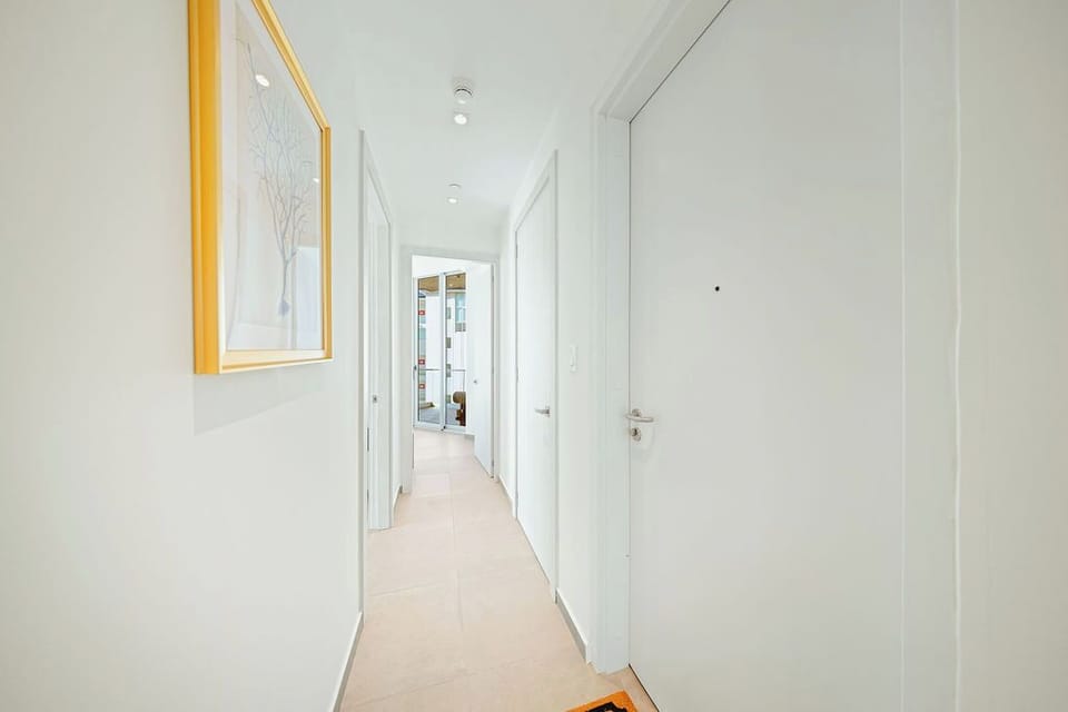 Your bright, spotless hallway leads to comfortable spaces throughout, with soft natural light creating a fresh and welcoming atmosphere.