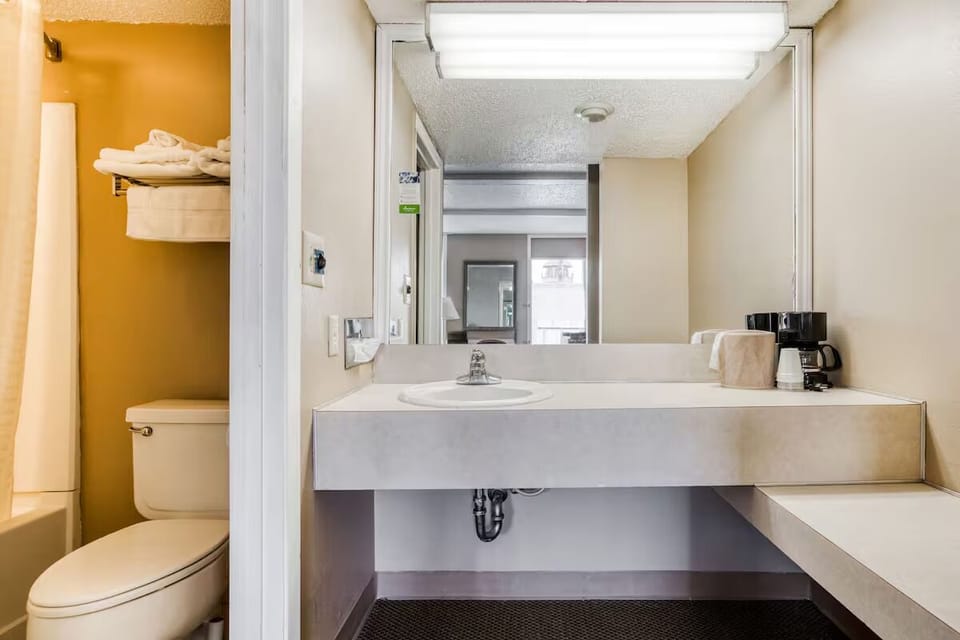 Freshen up at the spacious vanity under bright, clean light.