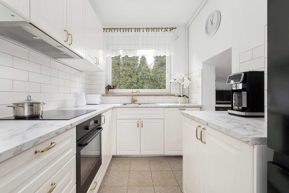 Modern, fully equipped kitchen with clean white cabinetry.