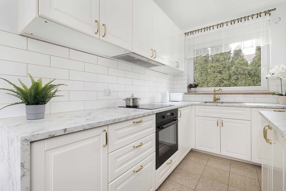 Functional kitchen with generous workspace and garden view.
