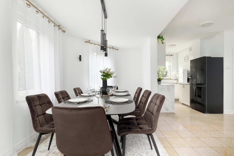 Bright dining room with modern furniture and open layout.