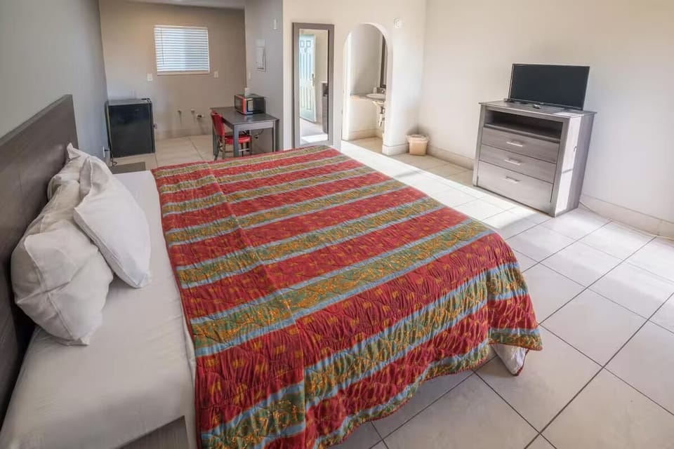 Recharge in airy space with cozy bedding and room to move.