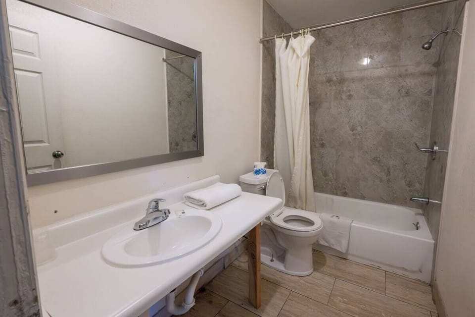 Start your day with a spacious vanity and tiled shower.
