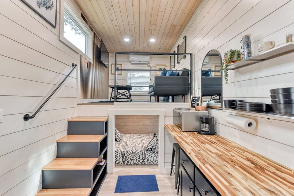 The living room and first bedroom are on the left side of the kitchenette