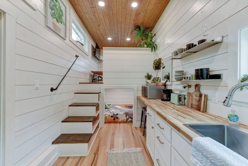 The living room and first bedroom are on the left side of the kitchenette