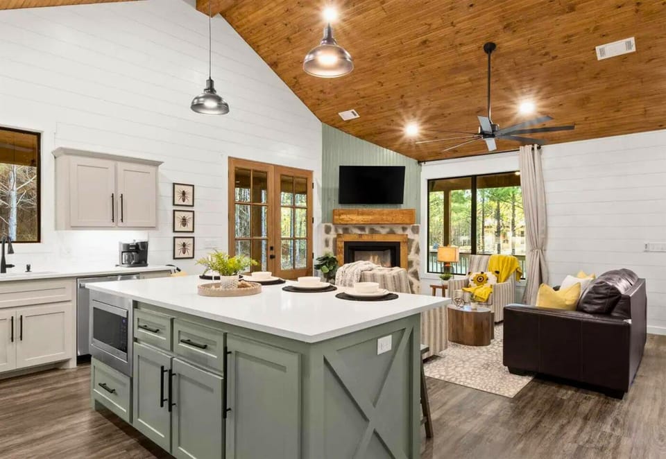 Gather around the spacious island while meals simmer, then sink into leather seating by your cozy fireplace.