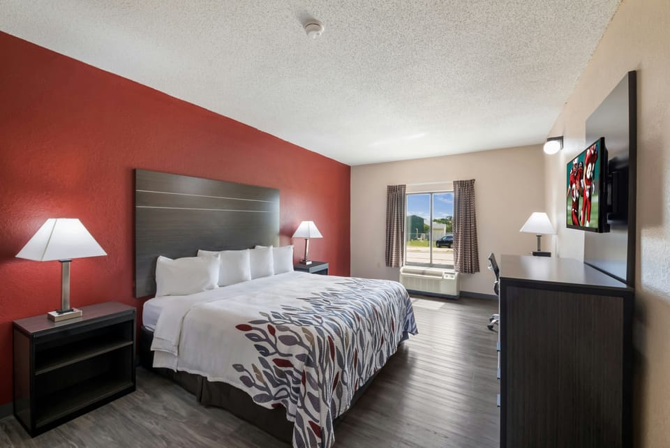 Relax into a plush king bed in a bright, airy room.