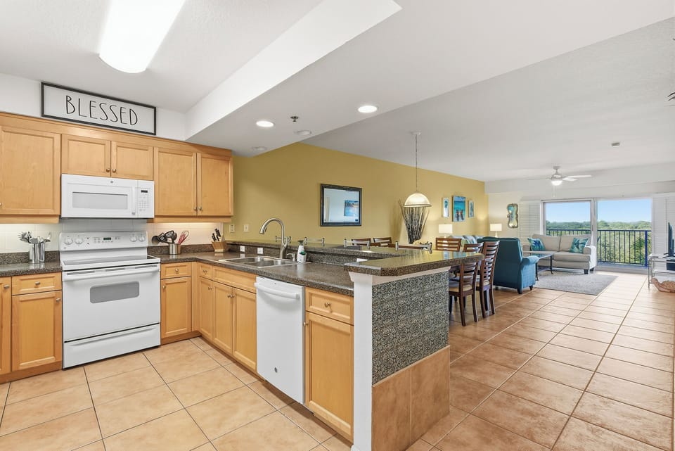 Your spacious kitchen flows seamlessly into the living area, where granite countertops and modern appliances await your culinary adventures.