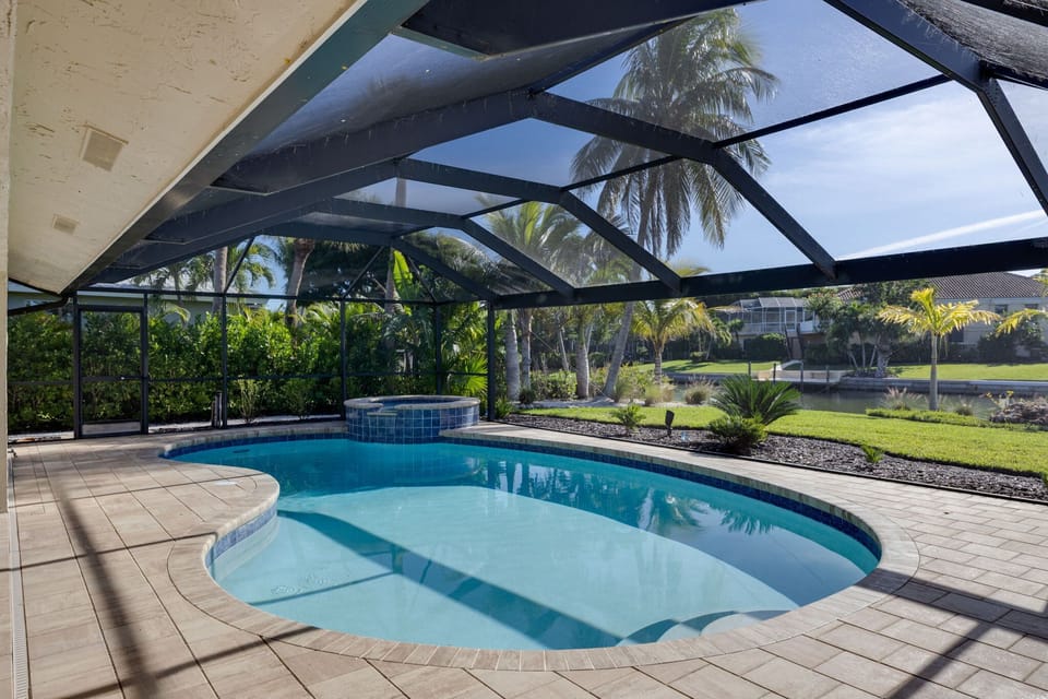 Heated and caged pool with pool lounge chairs