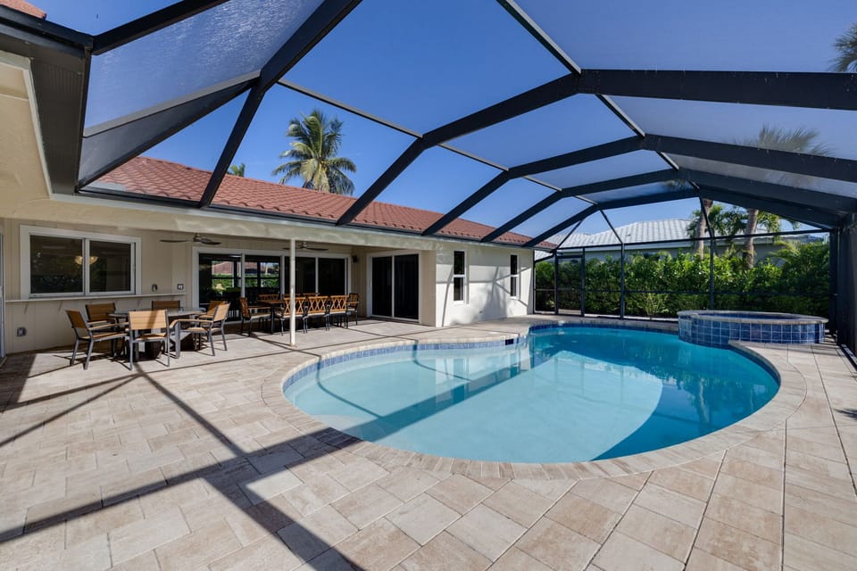 Heated and caged pool with pool lounge chairs