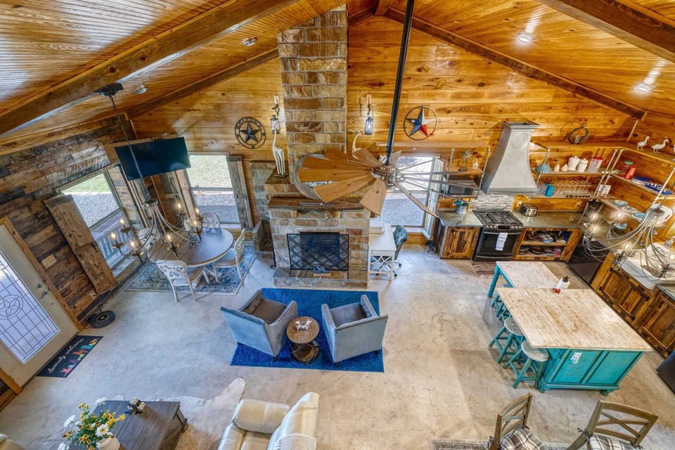 A stunning great room with soaring wood ceilings, stone fireplace, and open views-perfect for gathering and relaxing