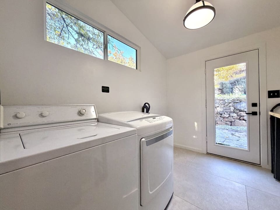 Full-size laundry room with washer, dryer, and direct outdoor access. Pack light, wash easy.