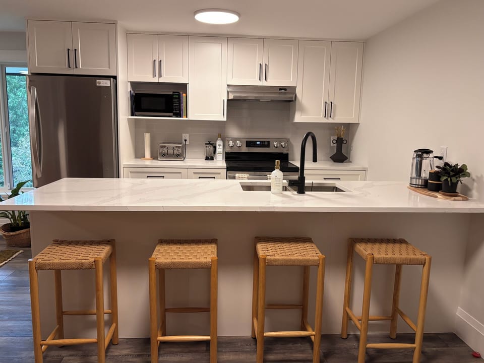 Bar seating near full kitchen. 