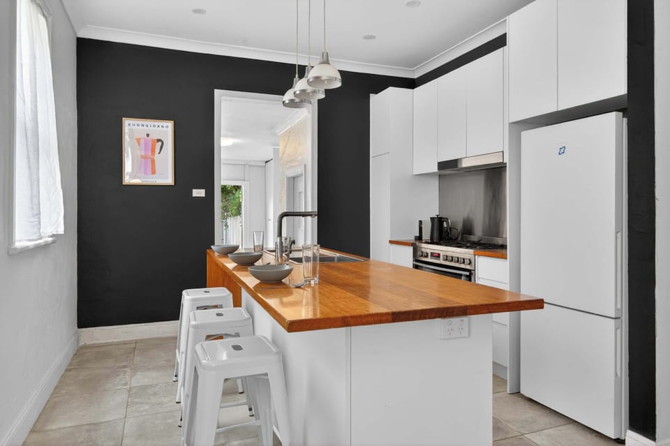 Open plan kitchen with great island and bar stools 