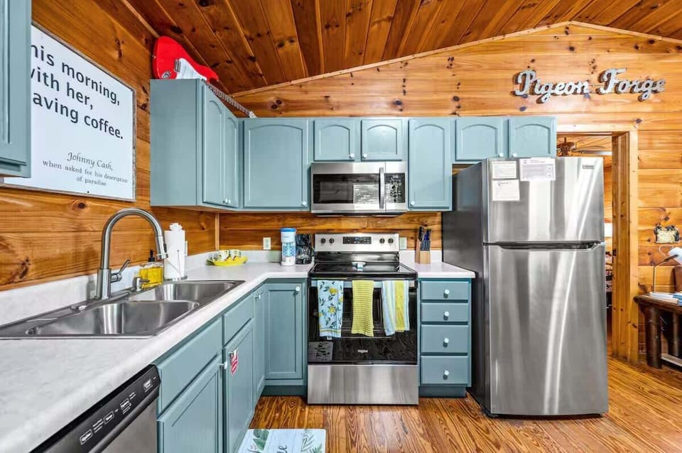 Pop of color in the teal kitchen—where rustic charm meets bold personality for your Smoky Mountain stay!