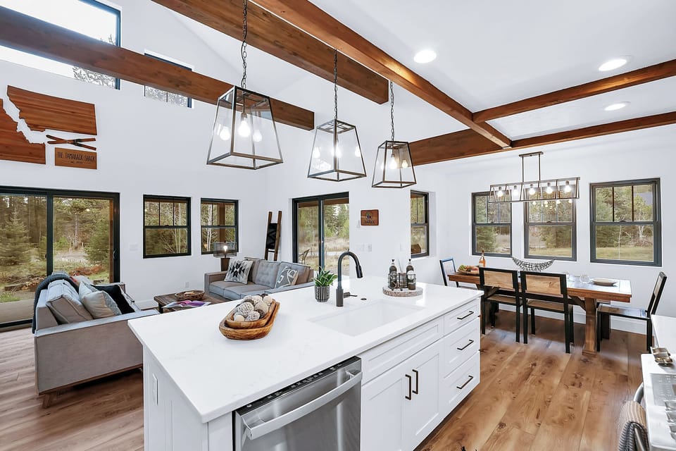 Open to the dining and living area, the kitchen keeps the cook in the conversation—perfect for snacks after skiing or family‑style dinners
