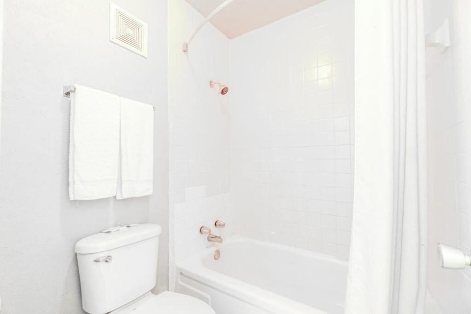 Rinse away the day in a clean tub-shower combo.