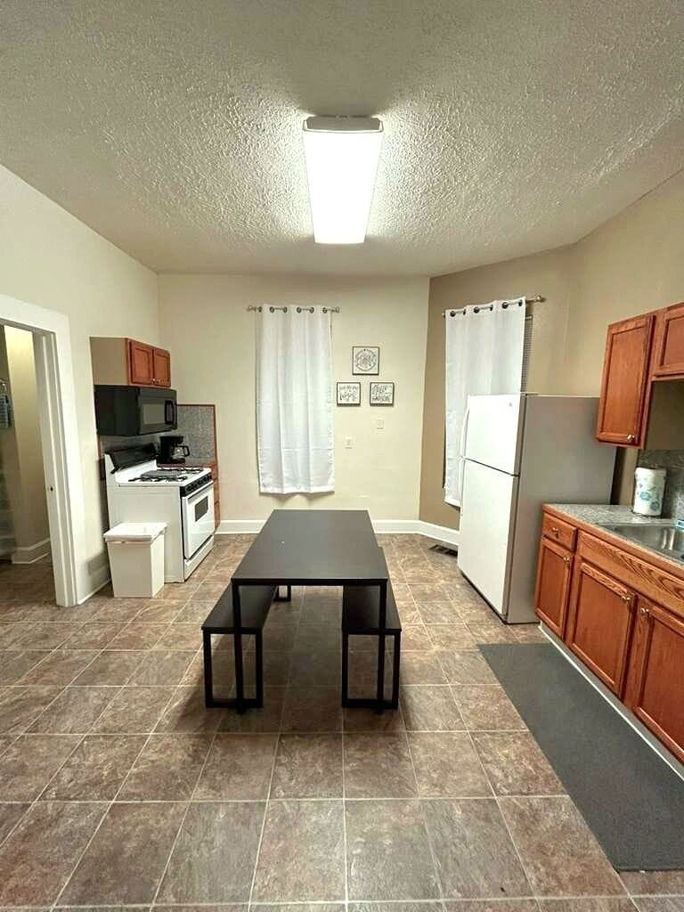Bright kitchen in Indianapolis! Enjoy modern appliances, a spacious dining table, and a clean, organized layout—perfect for cooking, dining, and relaxing during your stay.