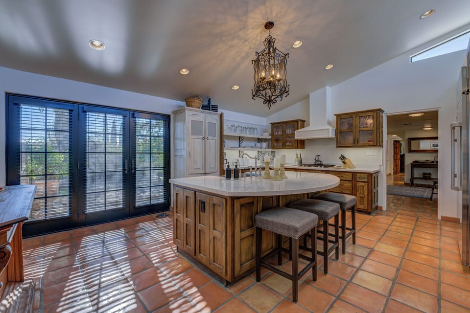 The kitchen French doors open onto a landscaped patio.