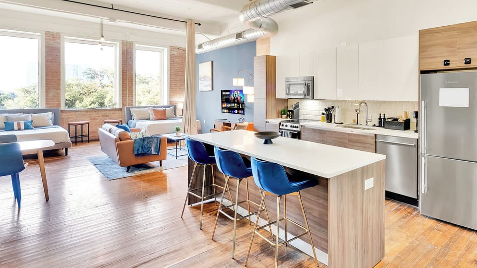 Fully equipped downtown Dallas loft kitchen with oversized island and bar seating.