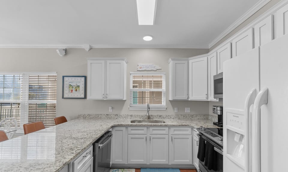 Your fully equipped kitchen awaits with granite counters, modern appliances, and everything you need to create memorable meals together.