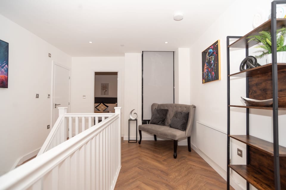 Spacious upstairs landing with seating in this duplex apartment.
