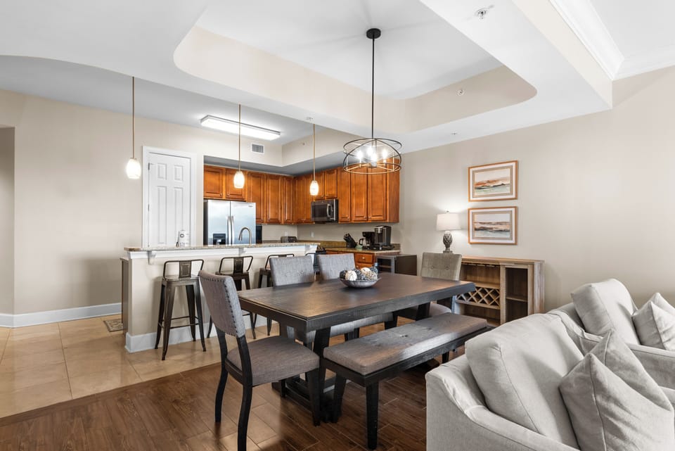 This spacious open-concept haven features a fully-equipped kitchen, elegant dining table, and plush seating for memorable meals together.