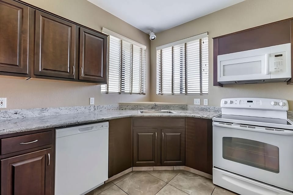 Prepare dinners effortlessly in a clean, corner kitchen setup.