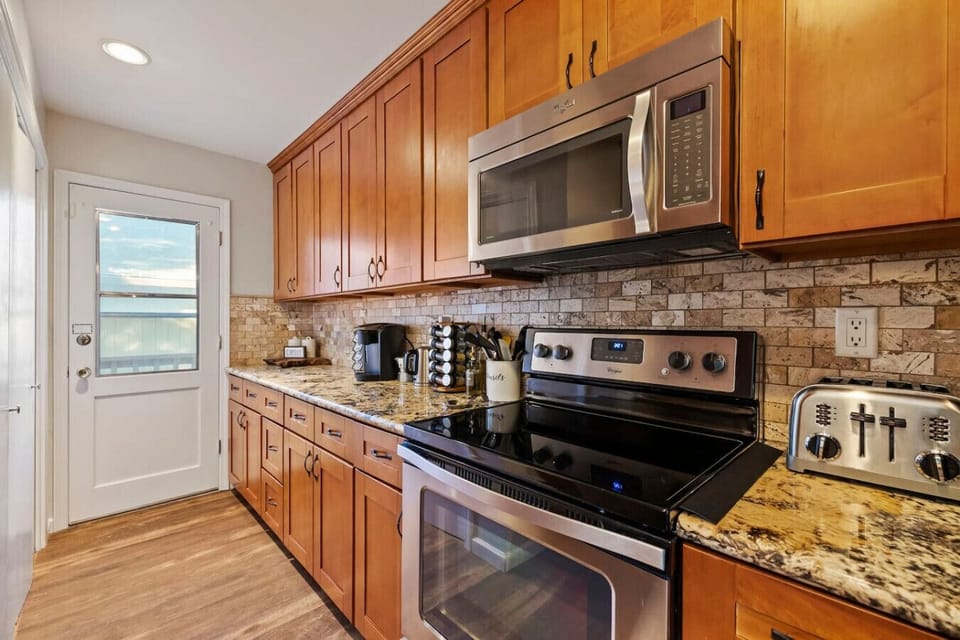 Modern appliances and a bright, open layout overlooking the forest.