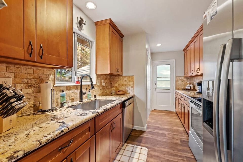 Modern appliances and a bright, open layout overlooking the forest.