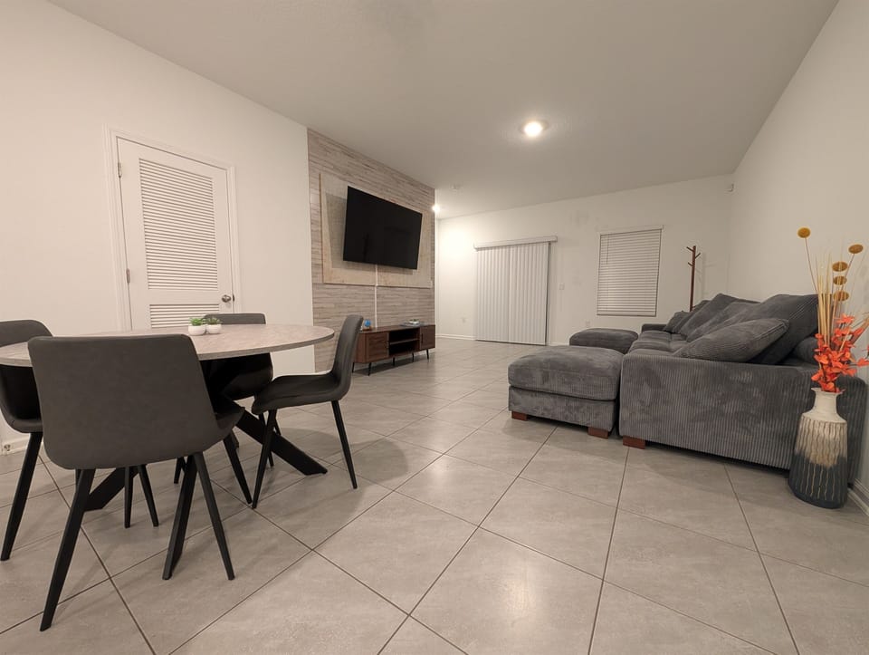 4 place kitchen table with a view of the TV in the background