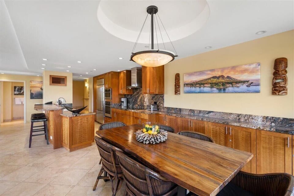 Gather around a beautifully crafted dining space, where rich wood and granite details create the perfect setting for unforgettable island meals.