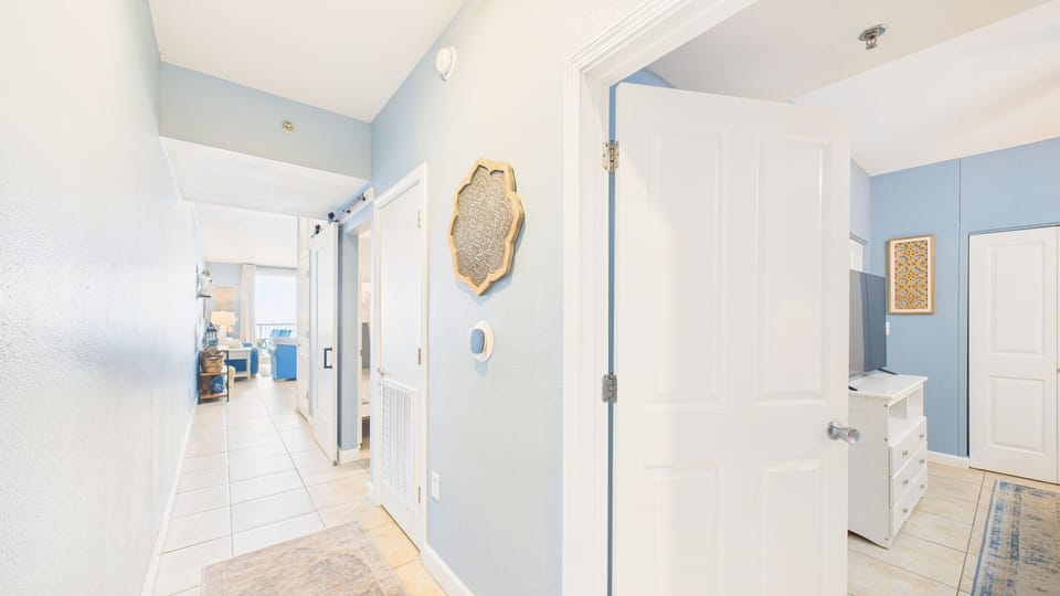 Walk into your unit where you'll find access to washer and dryer machines as well as bunk and bed rooms.
