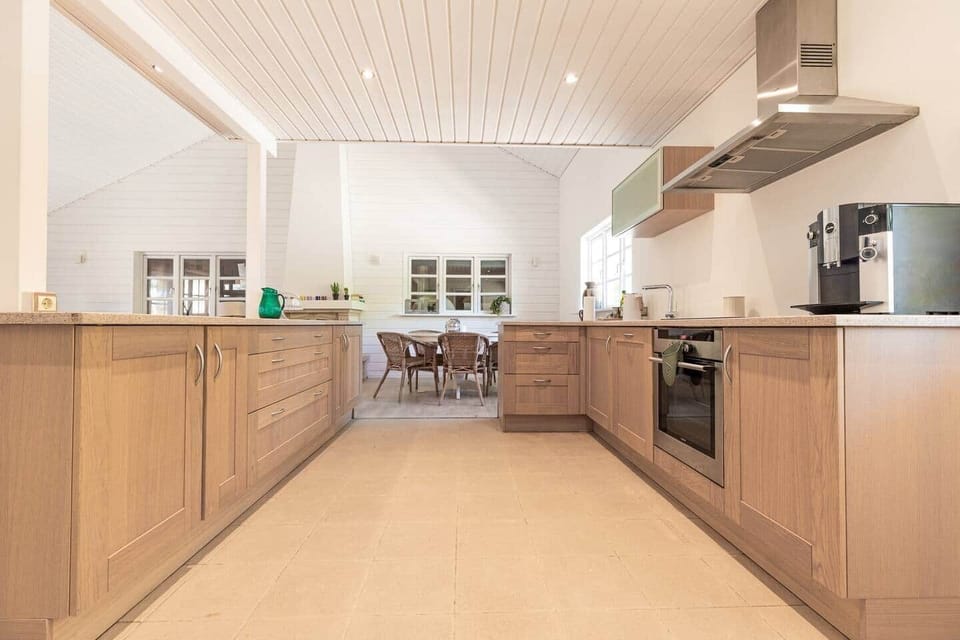 Casalot spacious kitchen with wooden cabinets and large countertop in Almancil Algarve country house