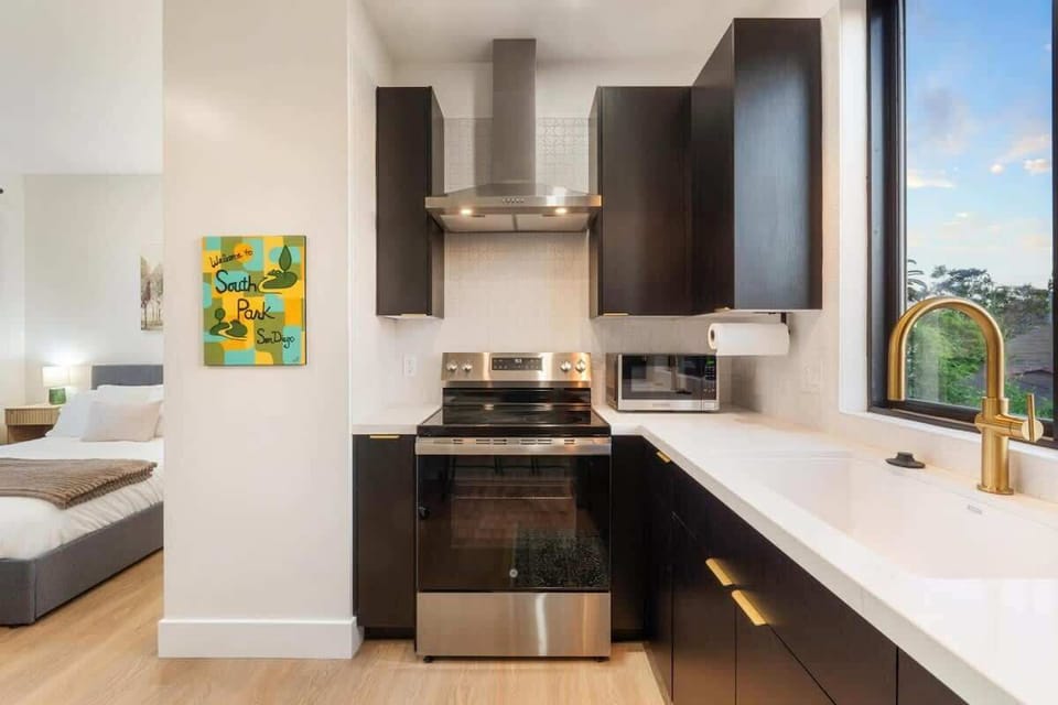 Bedroom with private workspace and kitchen access