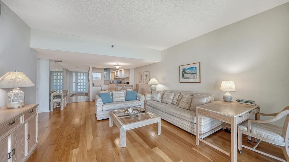 Spacious living room with cozy seating and warm hardwood floors