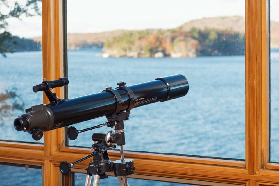 Telescope positioned for stargazing and lake views
