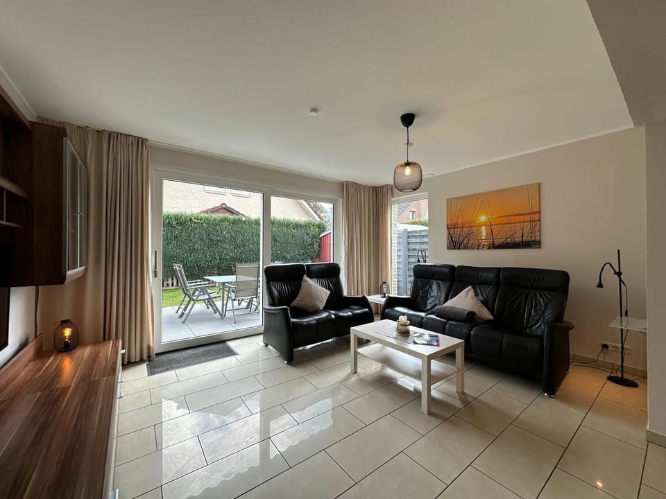 Cozy living room in modern design with direct access to the terrace.