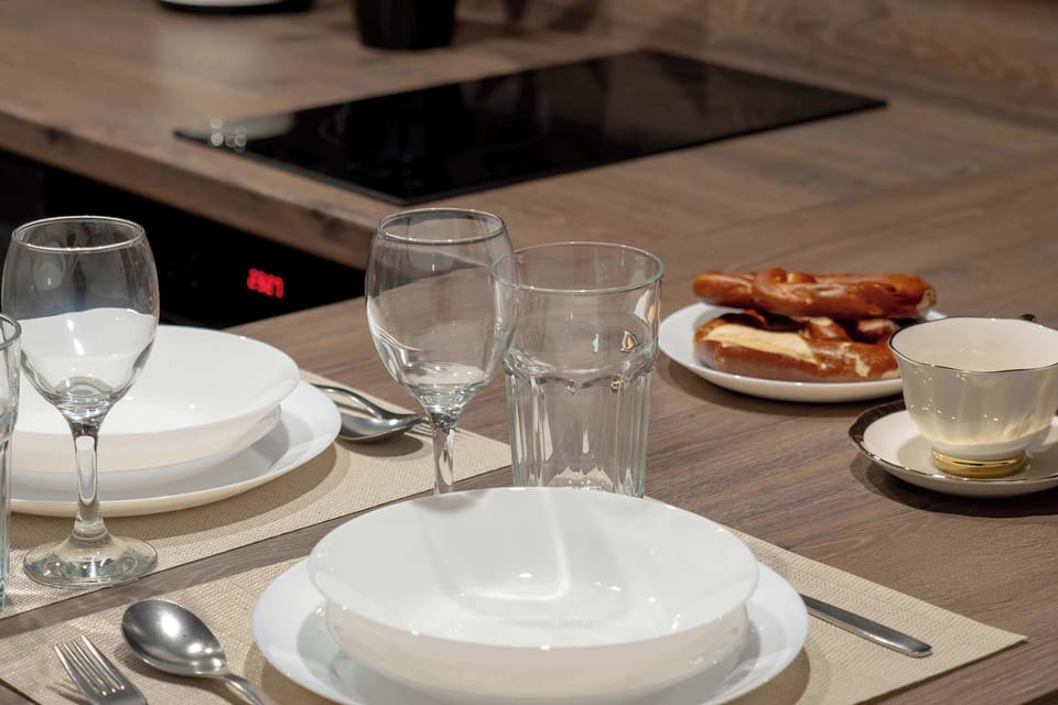 Inviting dining setup with tableware arranged on a wooden countertop.