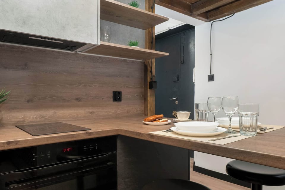 Functional kitchenElegant kitchenette corner with built-in appliances and clean lines.ette with contemporary cabinetry and warm wooden accents.