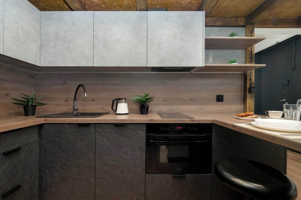 Functional kitchenette with contemporary cabinetry and warm wooden accents.