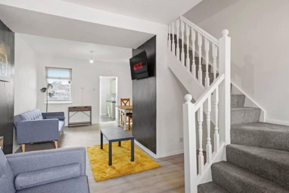 Open-plan lounge looking into kitchen and dining