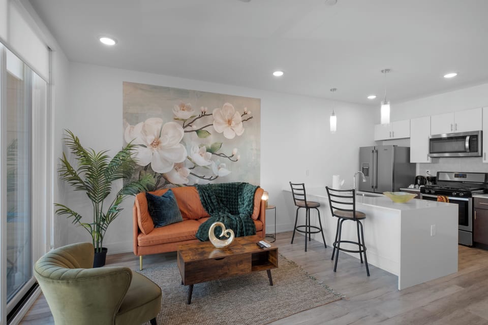 Smartly designed living space with a comfy couch, smart TV, and nice natural light.  