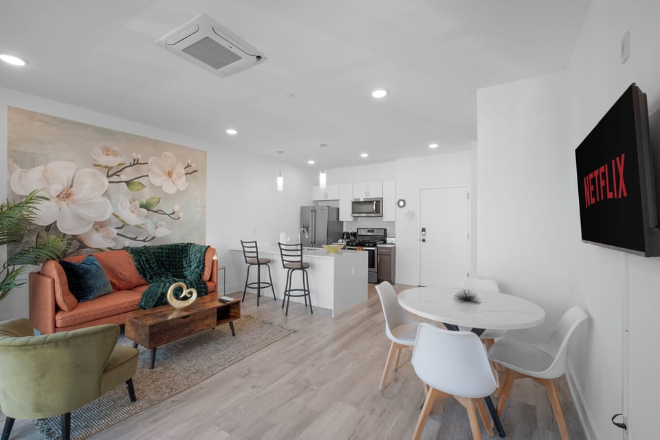 Open-concept living and dining area with hardwood floors maximizing space.