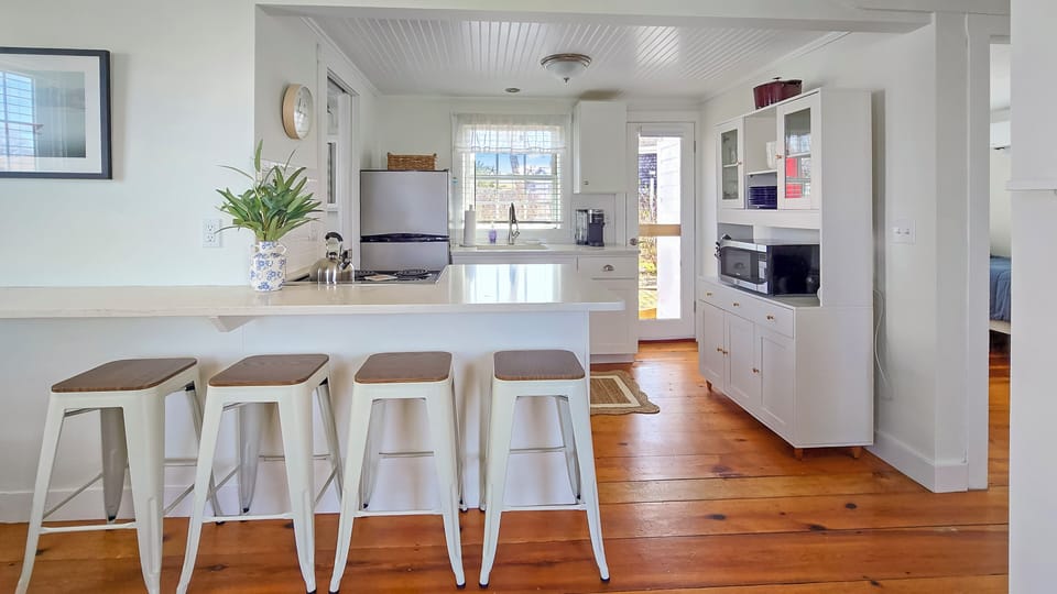 Bar seating for dining and the kitchen beyond
