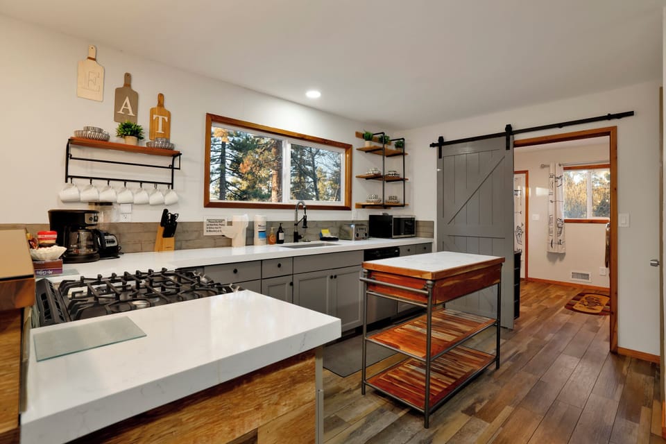 Fully equipped cabin kitchen with ample cabinetry, stove, fridge, microwave, and coffee maker—perfect for cooking meals, morning coffee, and feeling right at home on your stay.